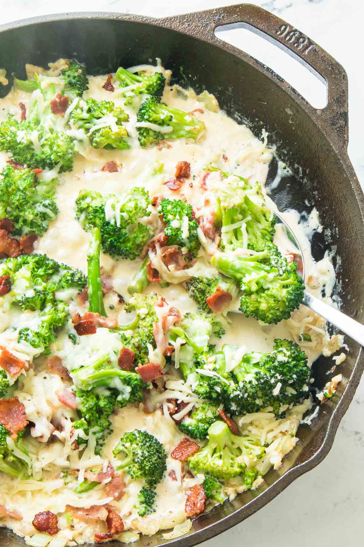 Broccoli and bacon in a creamy sauce in a skillet