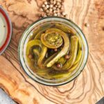 Overhead picture of pickled fiddleheads in a jar