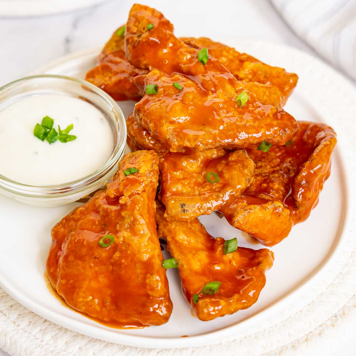 Buffalo sauce Chicken of the Woods "Wings" on a plate with blue cheese sauce