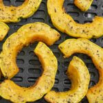 Delicata squash rings on an air fryer tray
