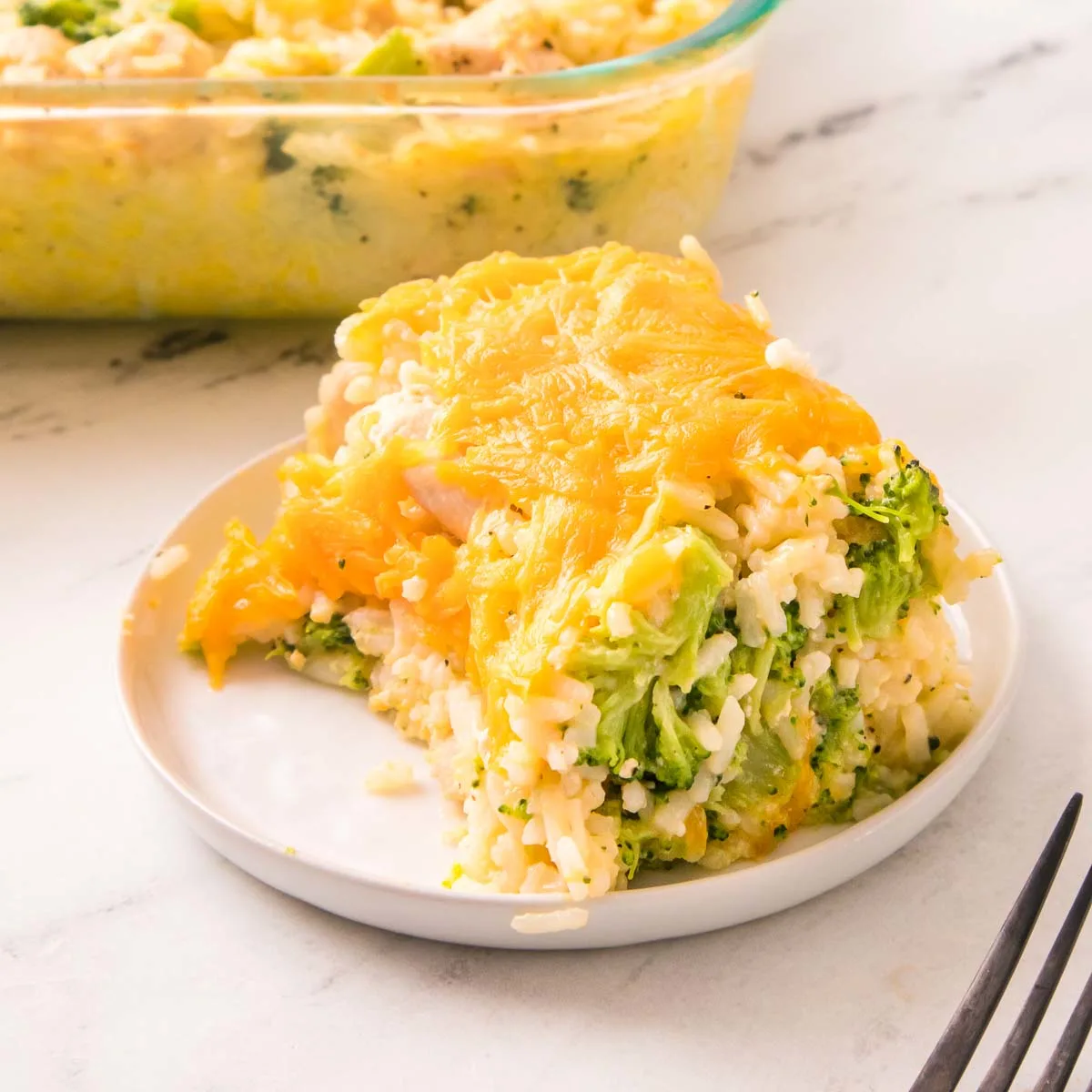 A serving of chicken, broccoli, and rice casserole topped with cheese.