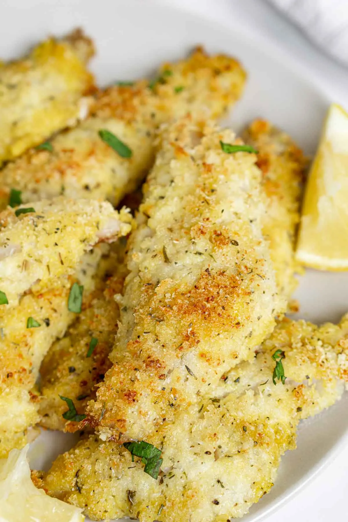 Plate of Parmesan crusted baked perch fillets.