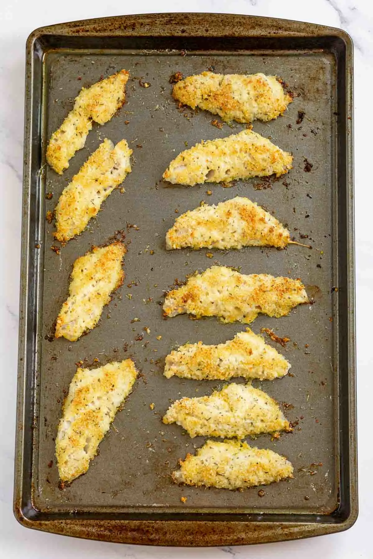 Baking sheet with baked perch fillets
