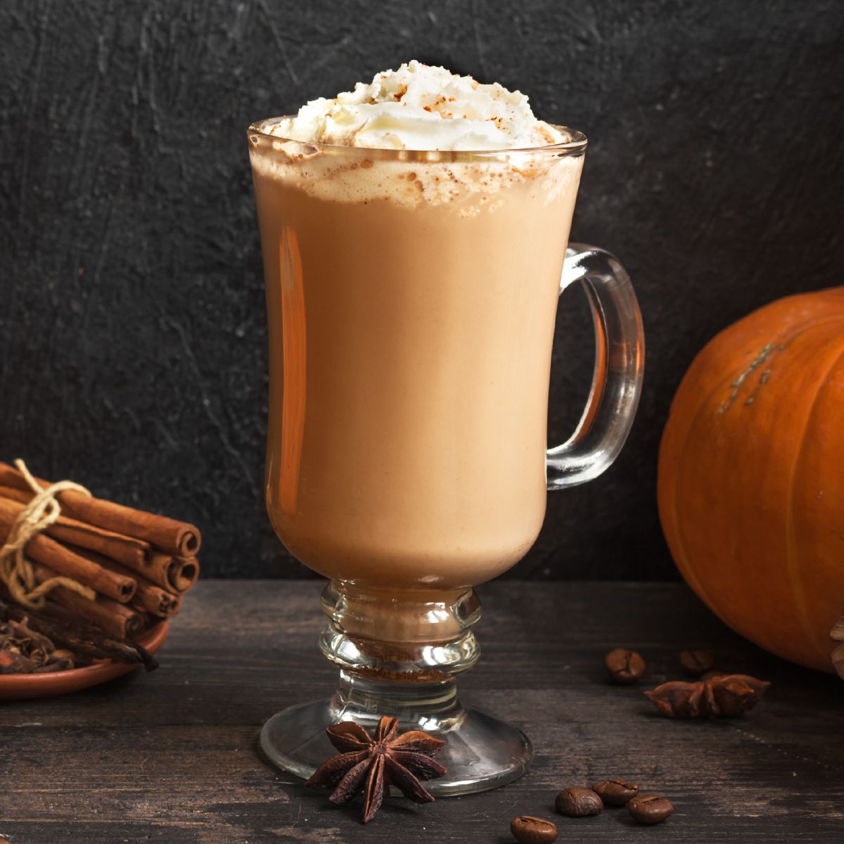Pumpkin spice latte in a glass topped with whipped cream