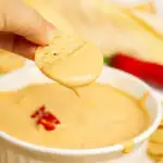Dipping a chip into a cottage cheese queso dip