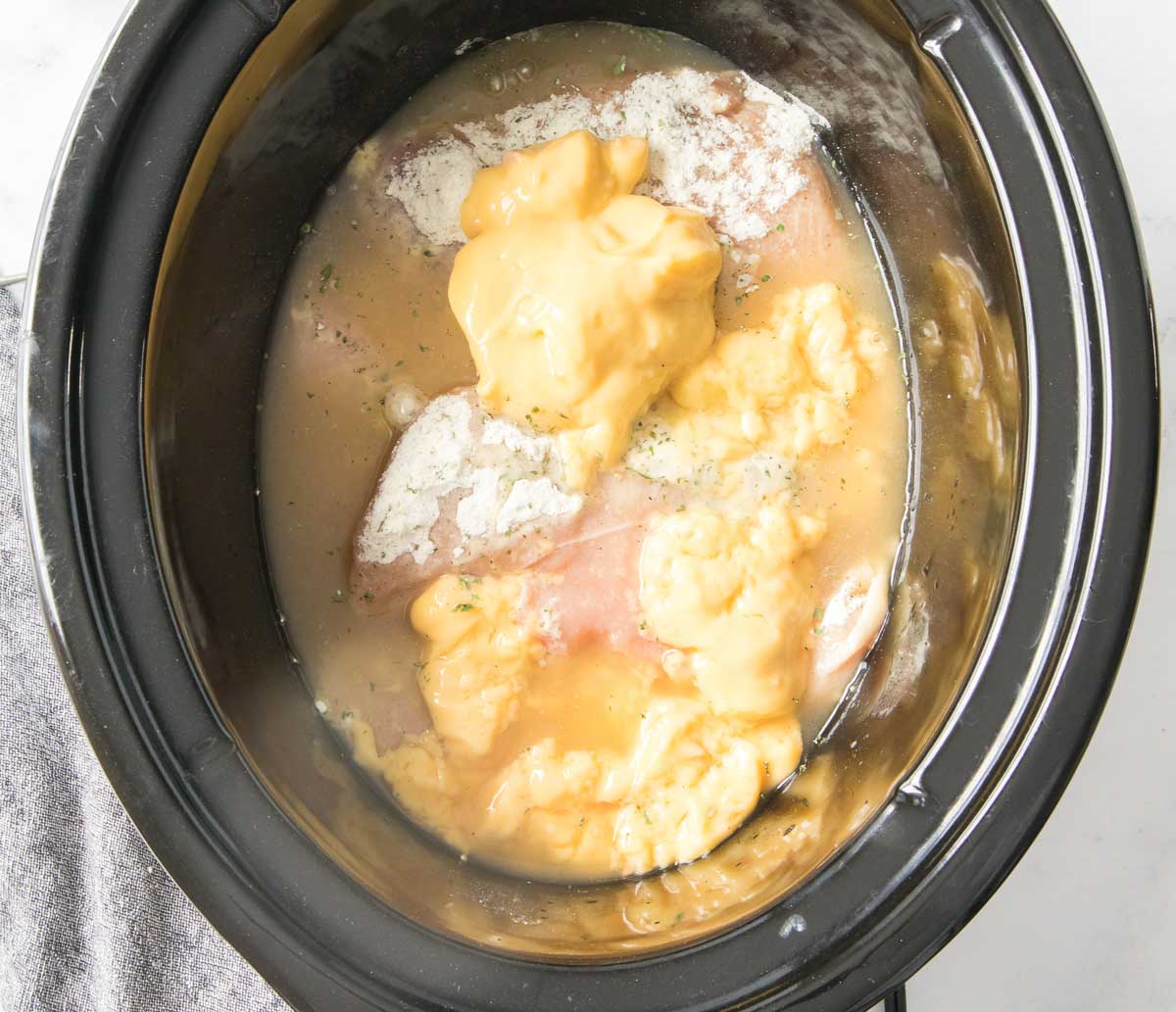 Ingredients for chicken and gravy in a slow cooker