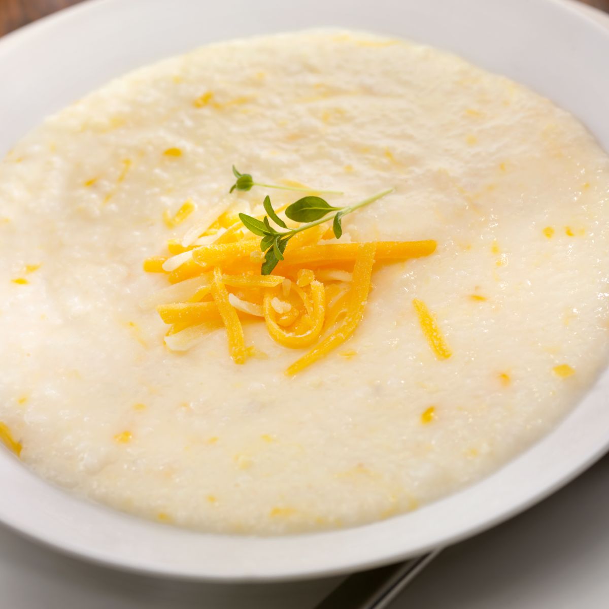 Bowl of grits with shredded cheese on top