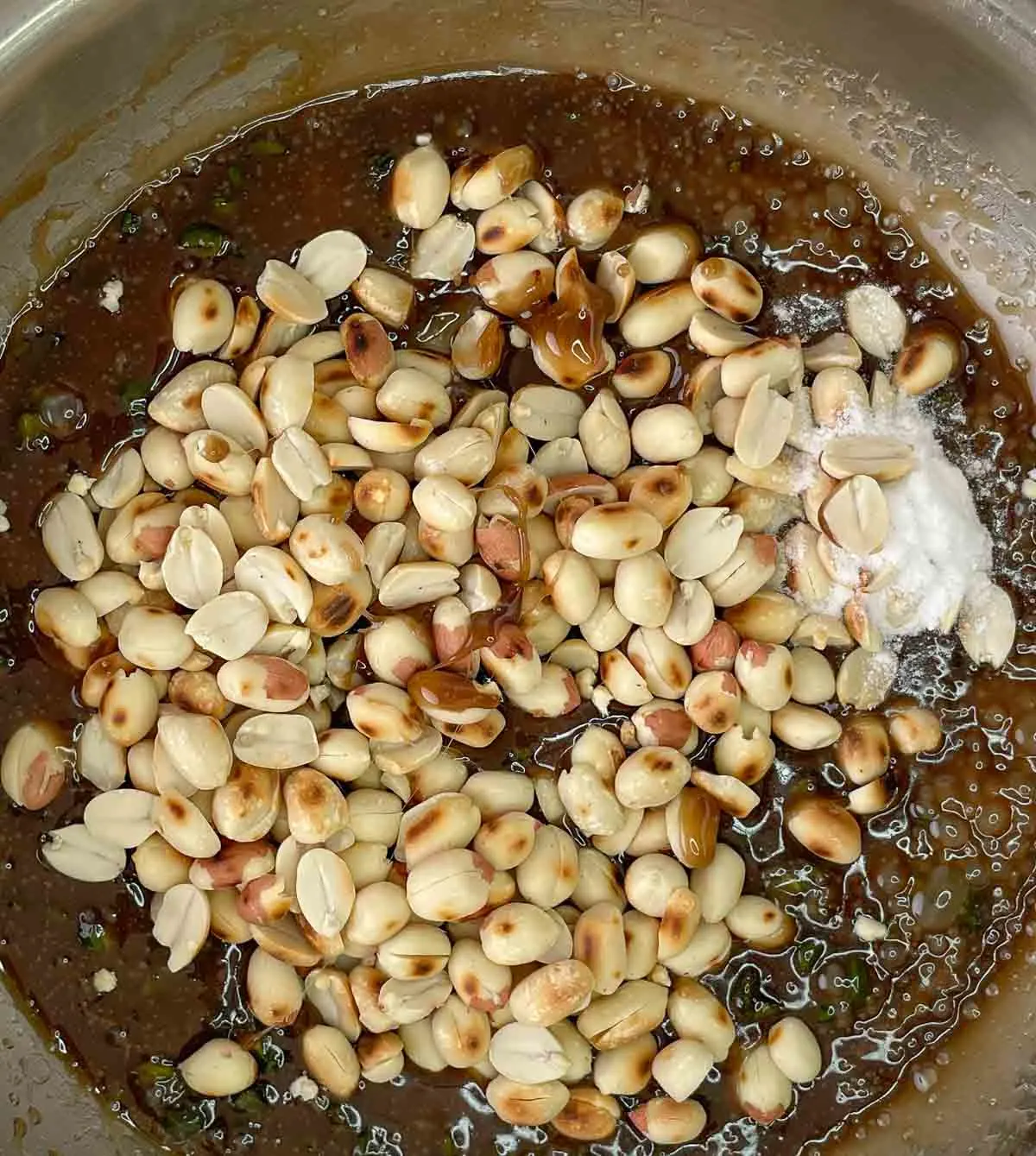Adding peanuts to melted sugar