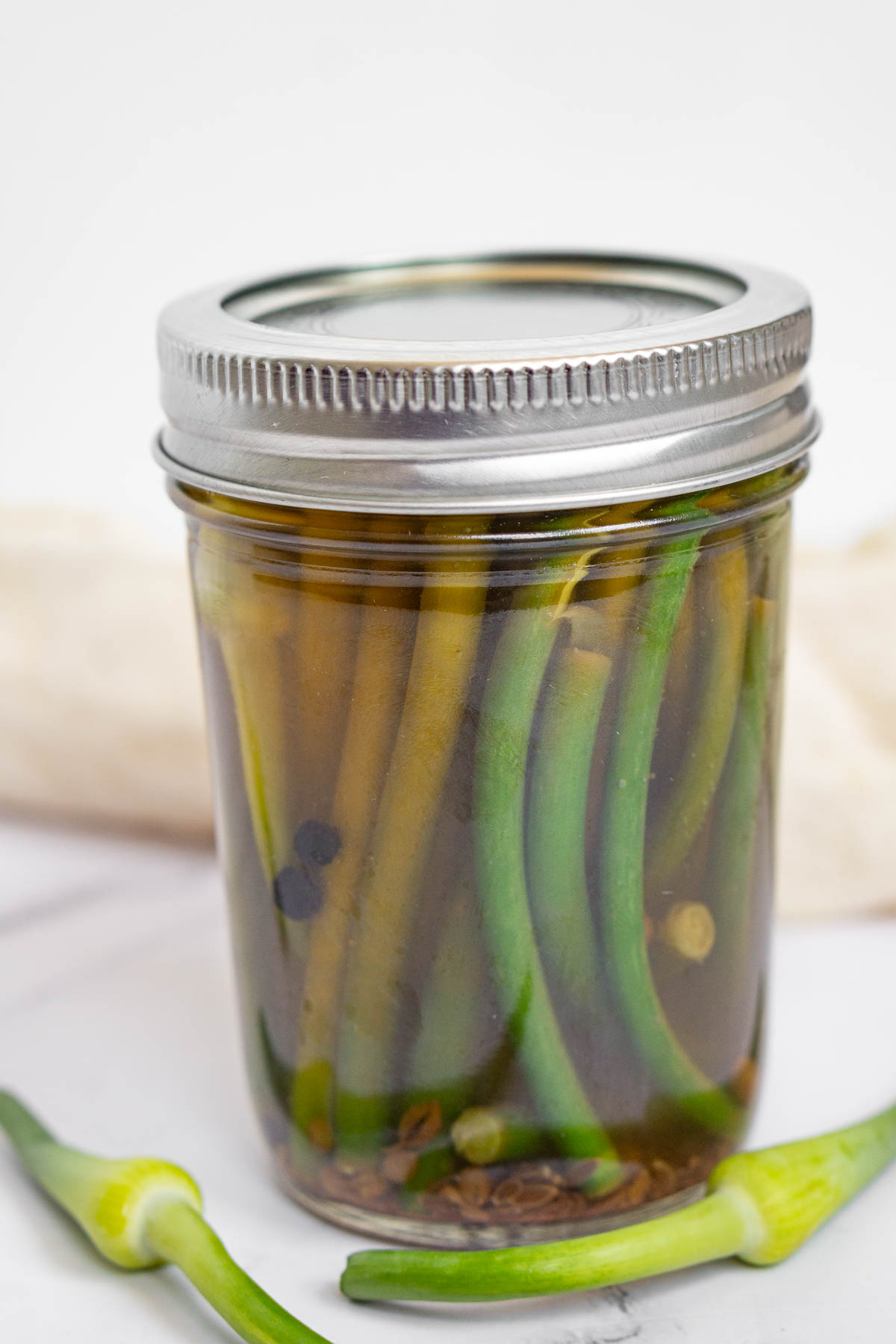 Jar of pickled garlic scapes