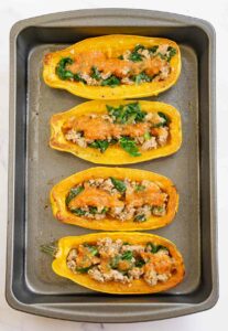 Picture showing how to stuffed delicata squash halves.