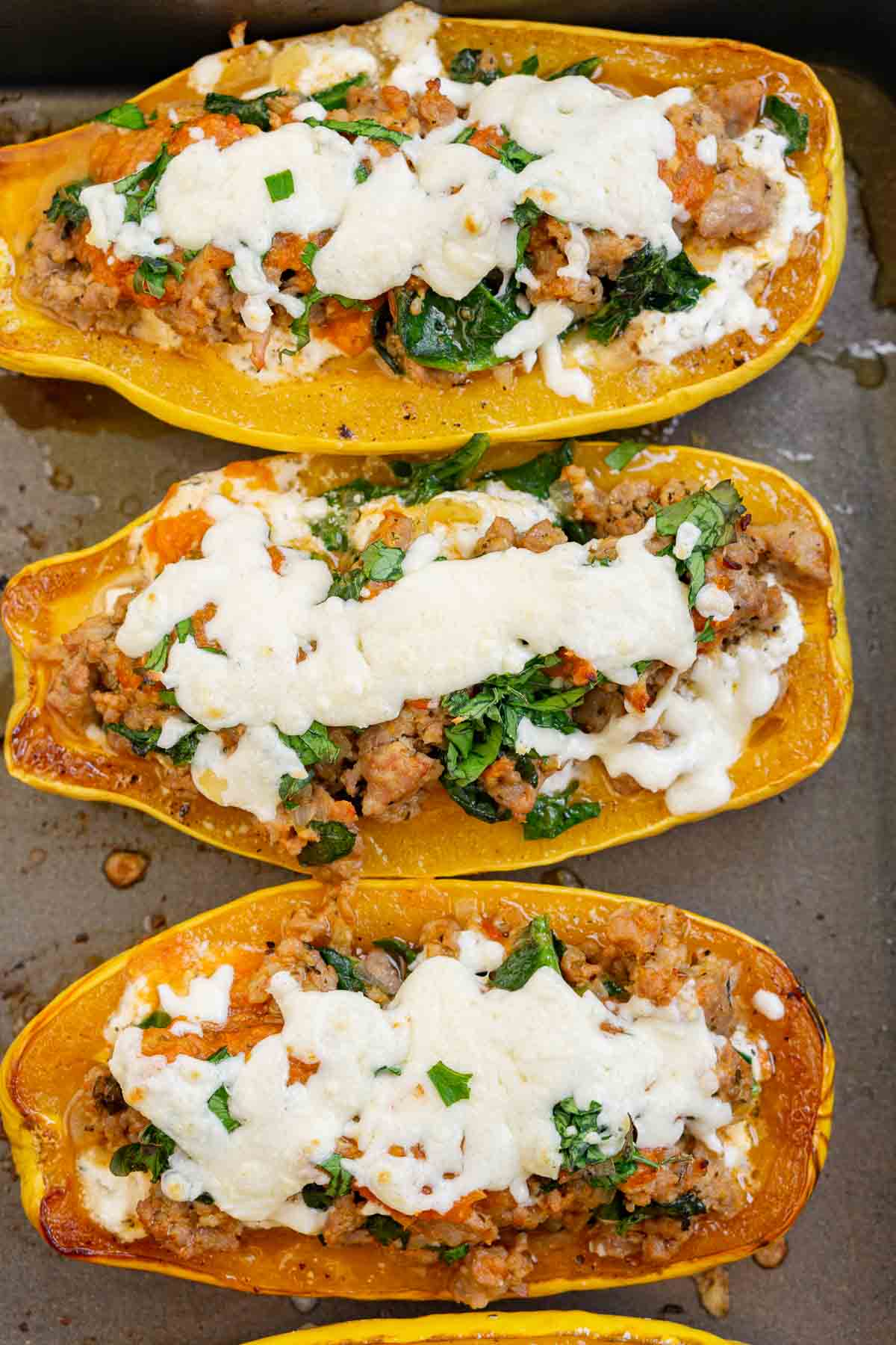 Baked stuffed delicata squash in a baking pan