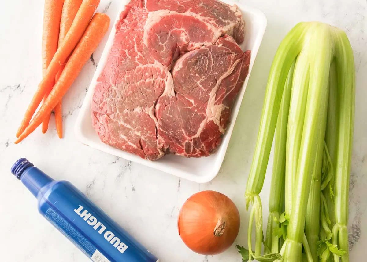 Ingredients to make pot roast in a slow cooker