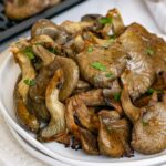 Close up or oyster mushrooms cooked in the air fryer.