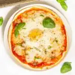 Breakfast tortilla pizza garnished with basil