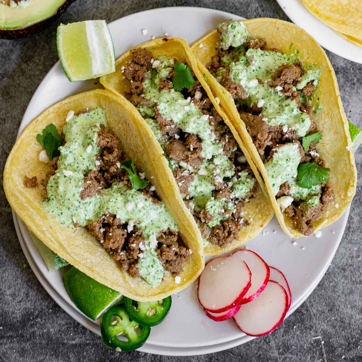 Venison Tacos topped with Aji Verde on a plate