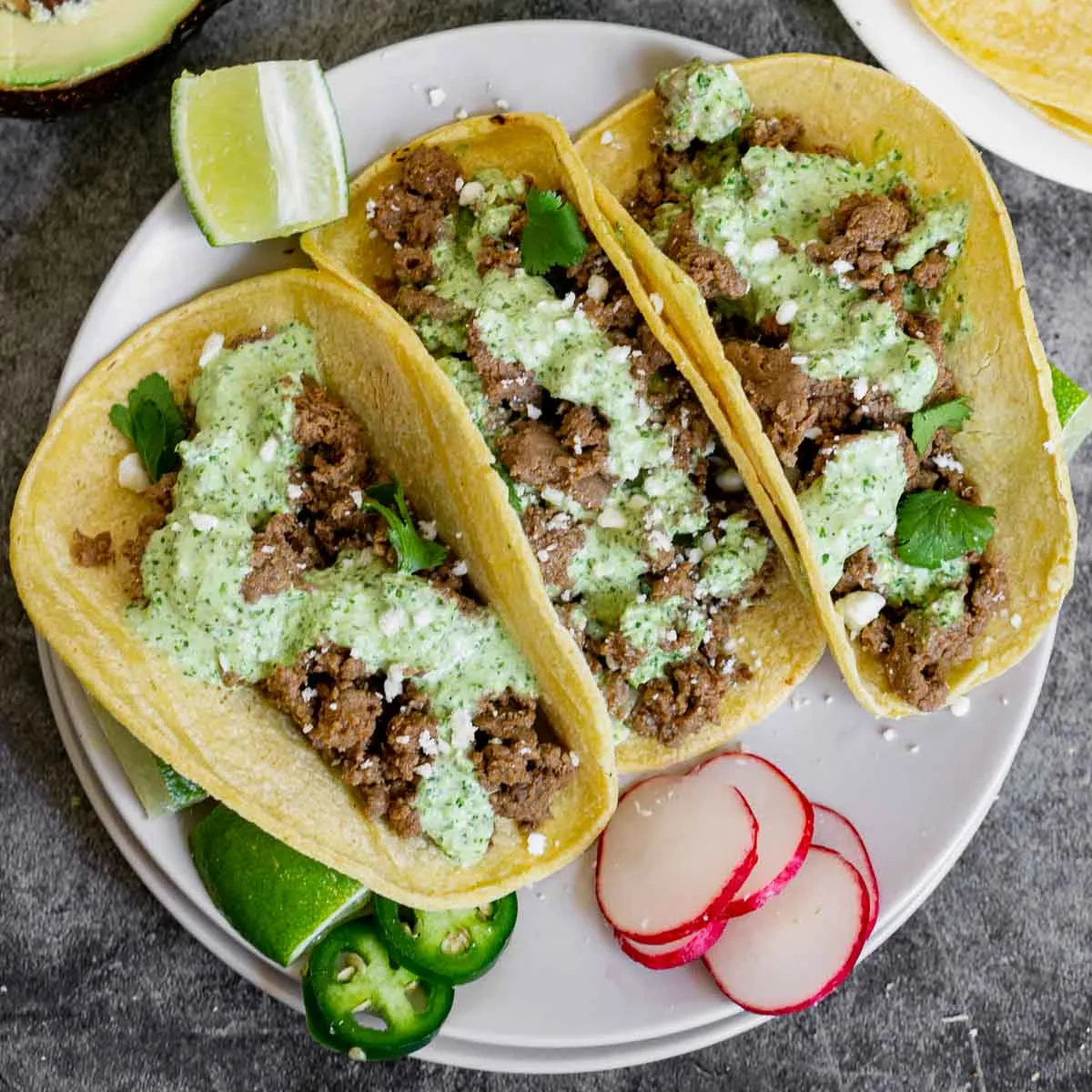 Venison Tacos topped with Aji Verde on a plate