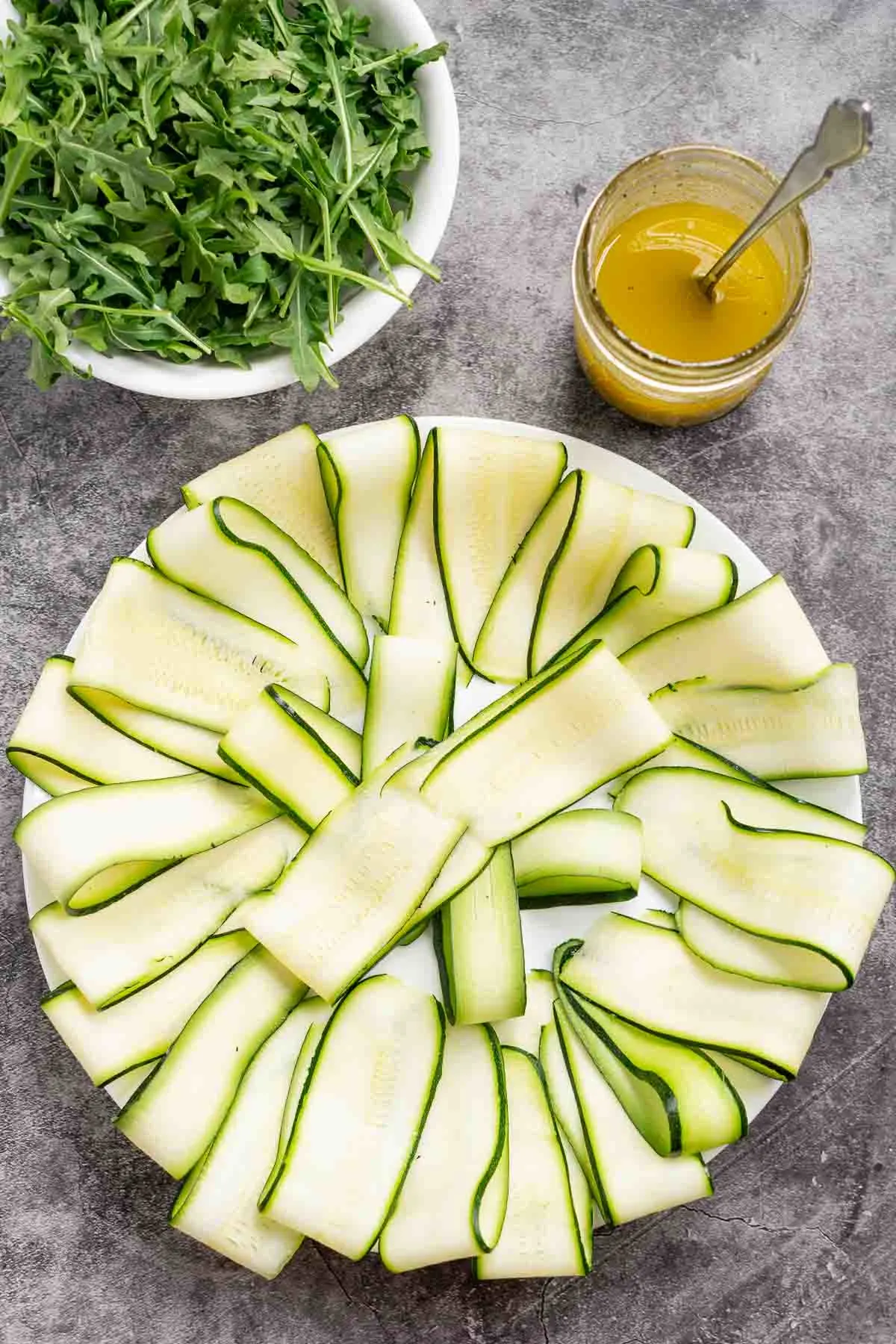 Sliced zucchini ribbons arranged on a plate