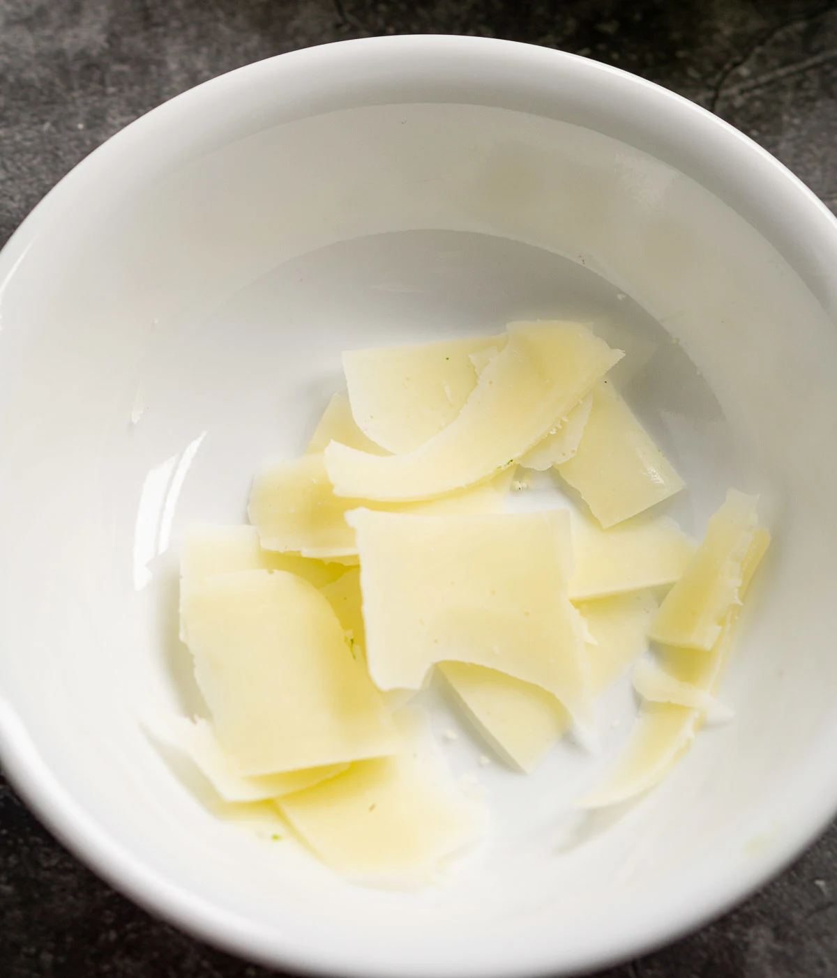 Pieces of shave Parmesan cheese in a bowl