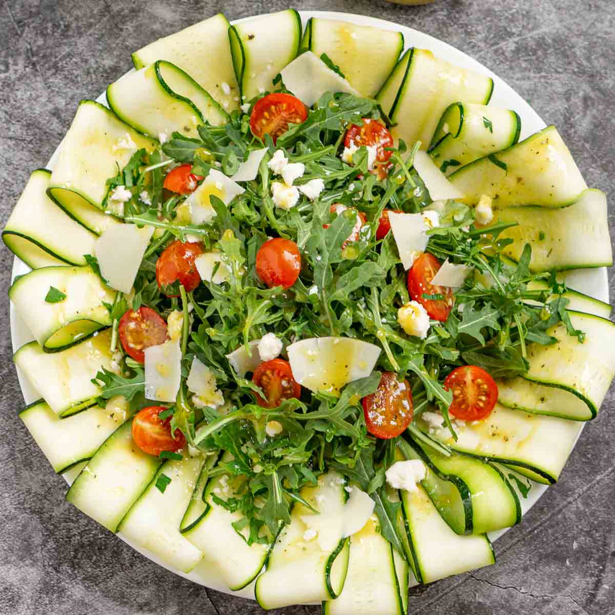 Zucchini carpaccio salad arranged on a platter