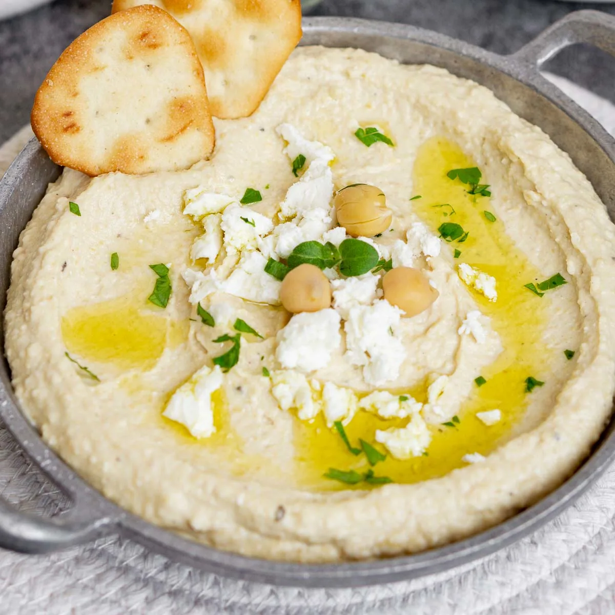 Close up of feta hummus with a cracker in it