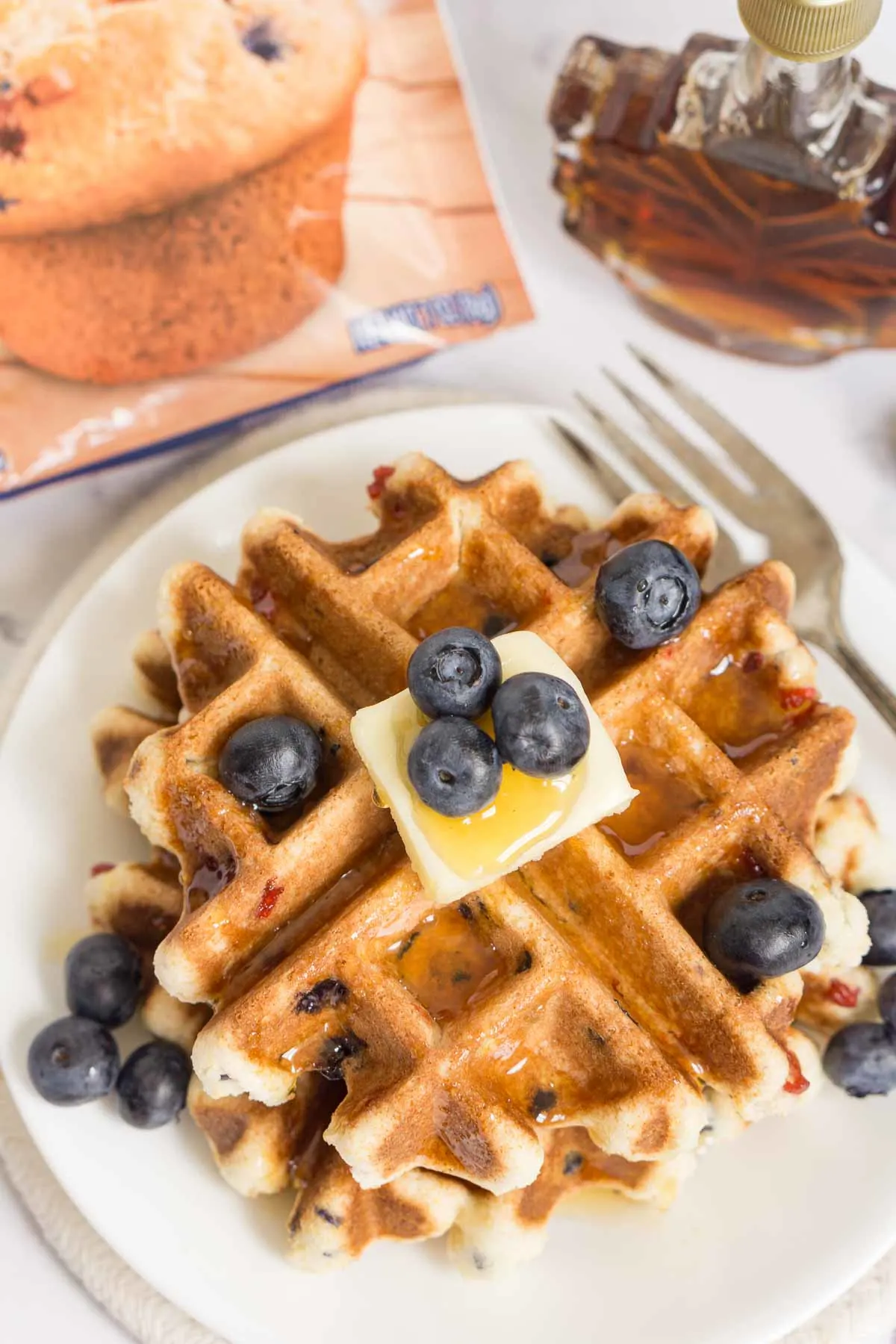 Overhead picture of waffles made from muffin mix, with a muffin mix packet next to them.