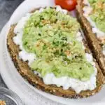Close up of toast with cottage cheese topped with mashed avocado