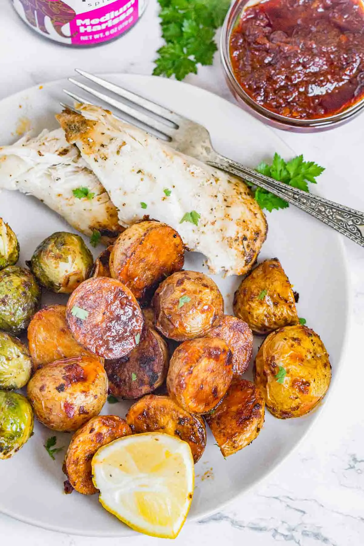 Plate of chicken, Brussels sprouts, and harissa potatoes