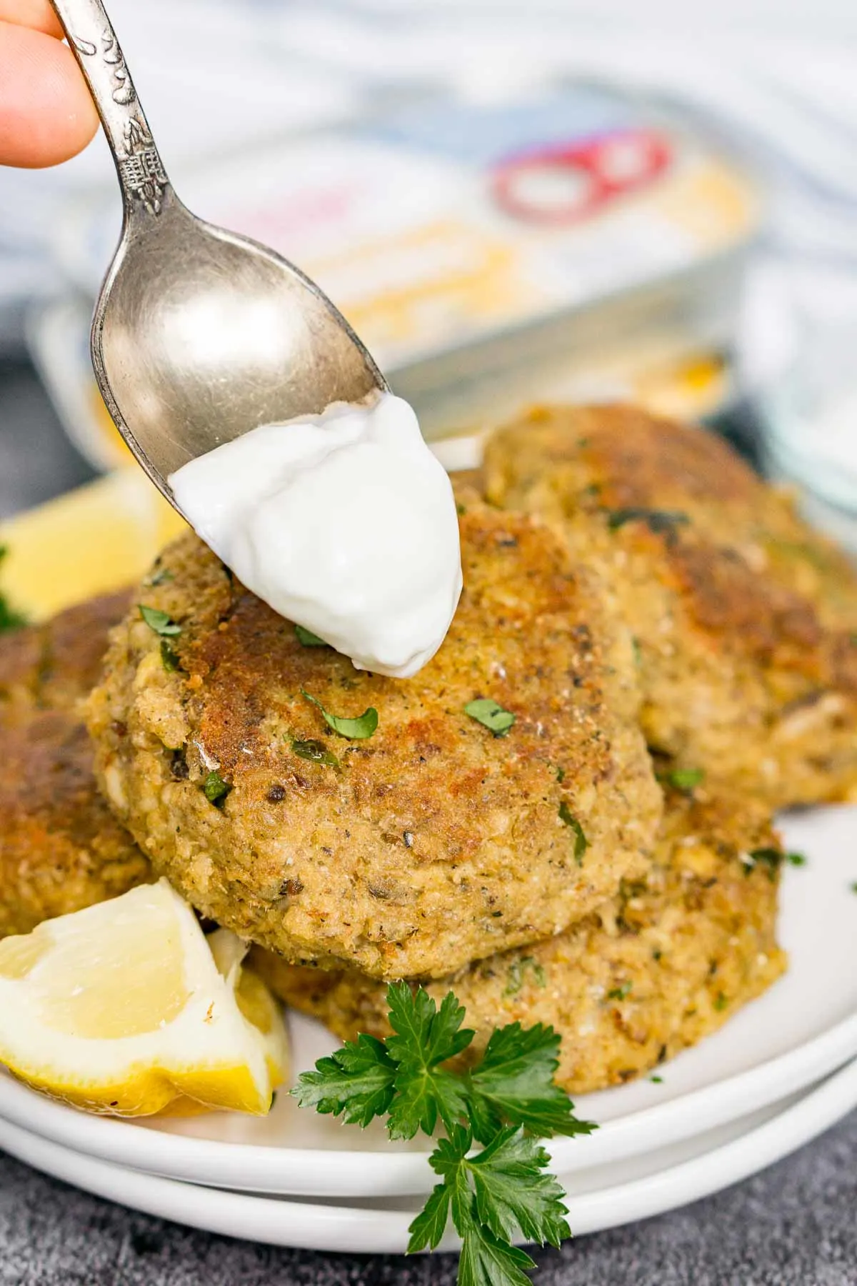 Adding a dollop of sour cream to a sardine cake