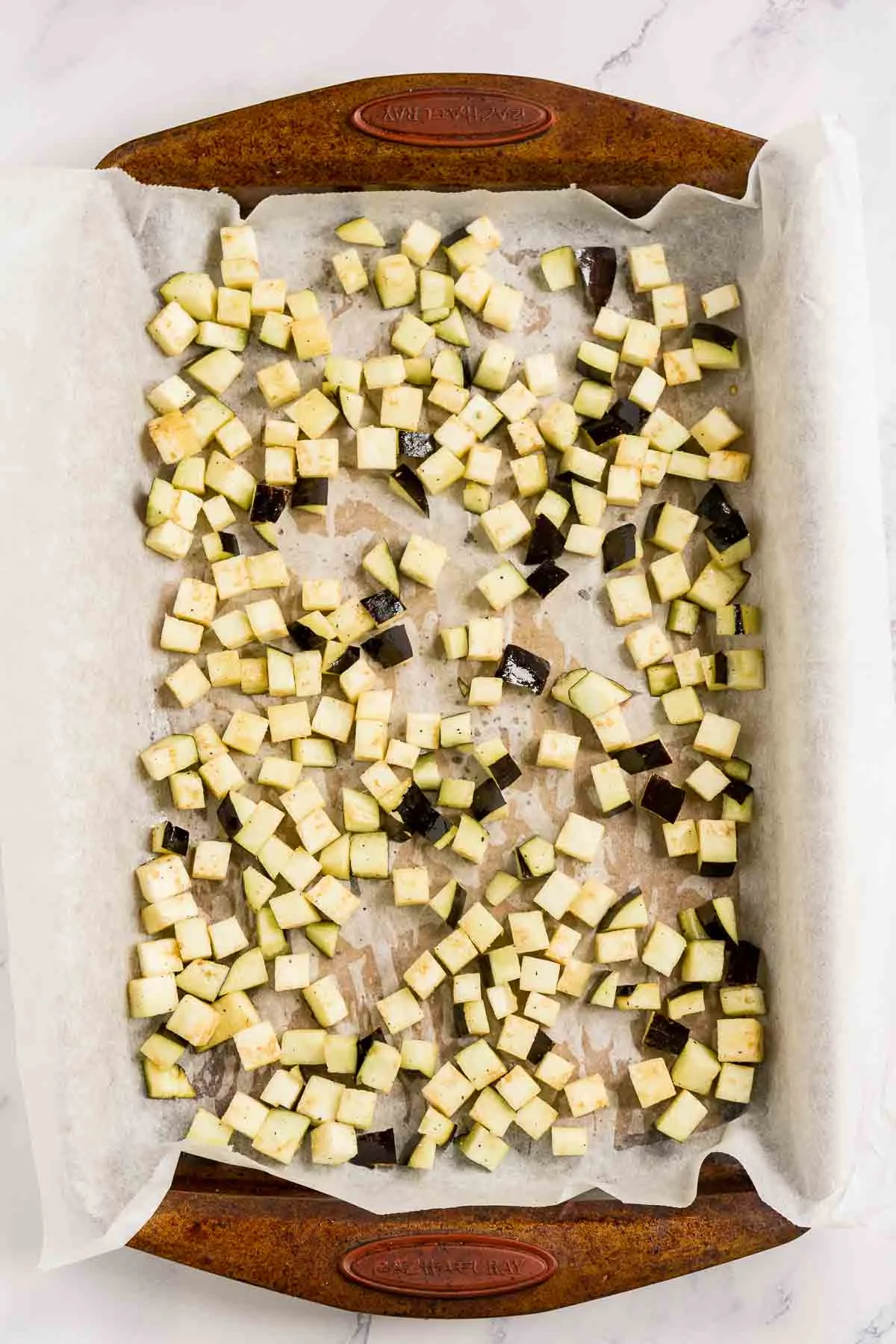 diced eggplant on a baking sheet