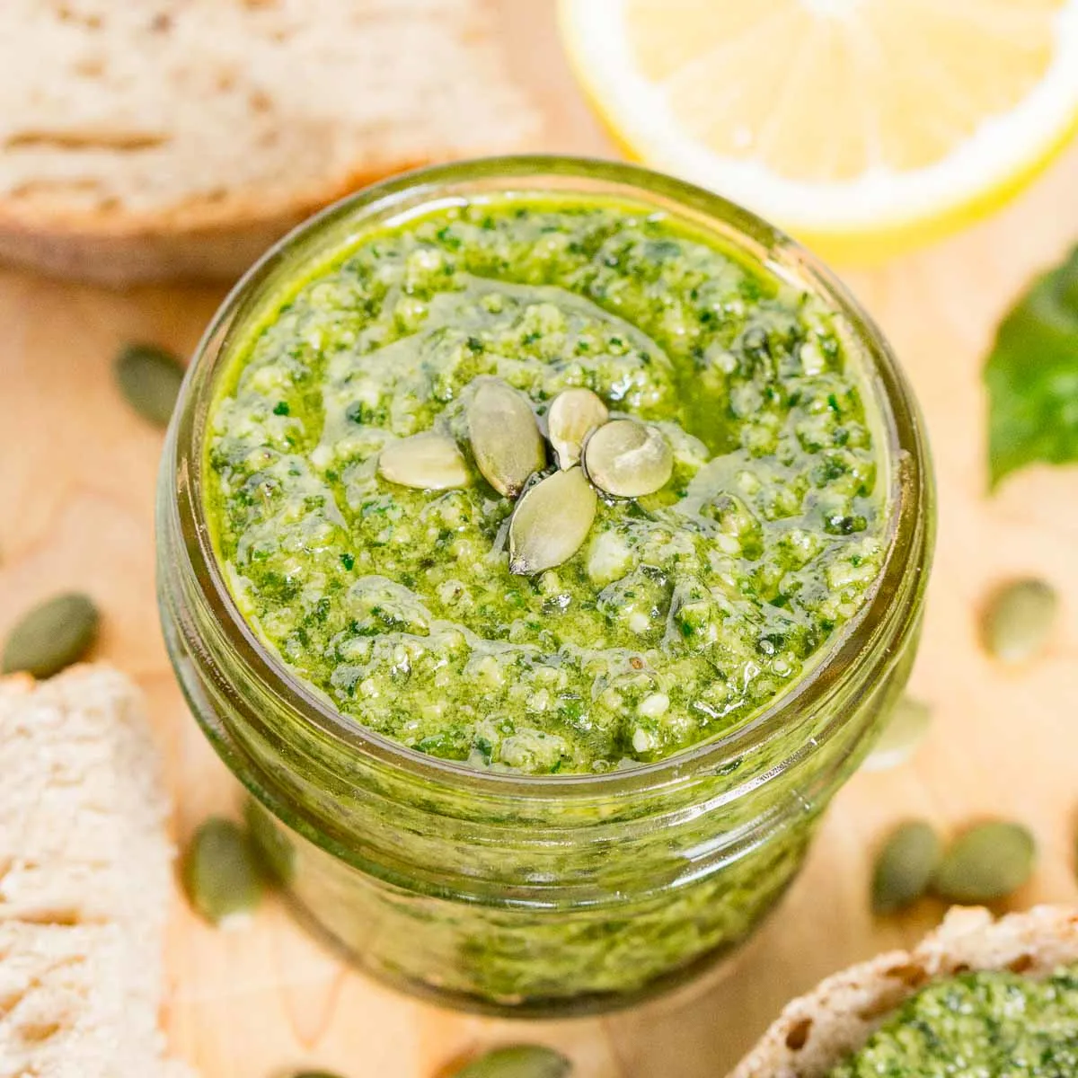 Jar of pesto topped with pepitas