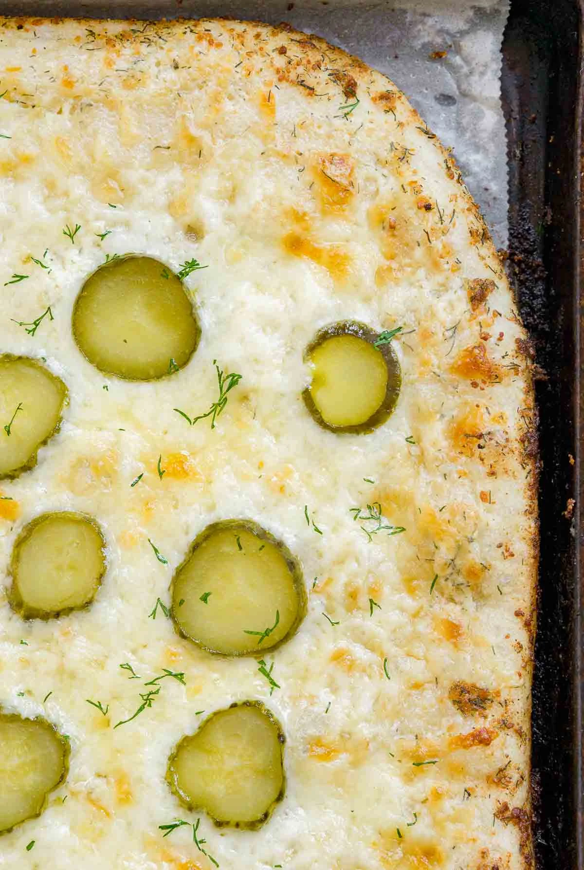 Homemade pickle pizza on a baking sheet