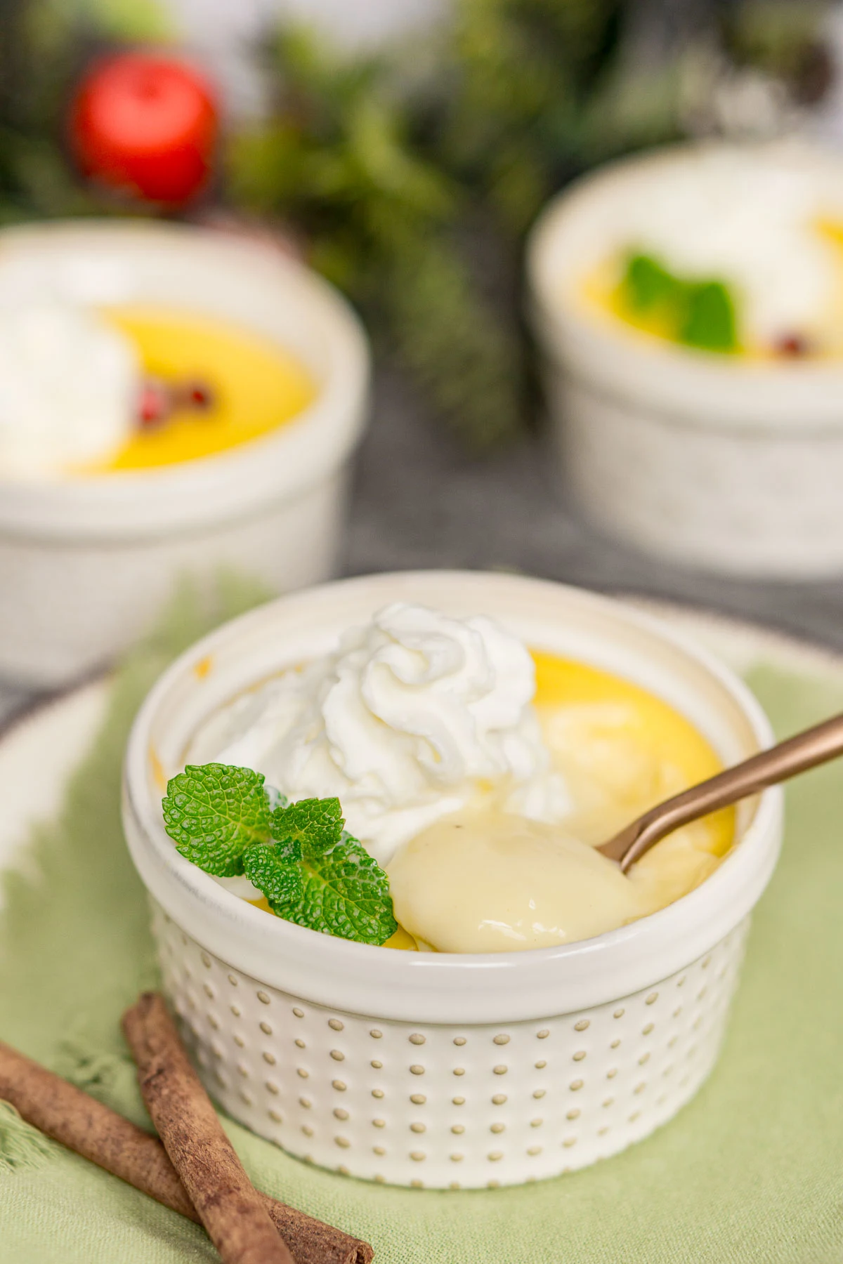 Spoon scooping eggnog pudding out of a ramekin to show texture
