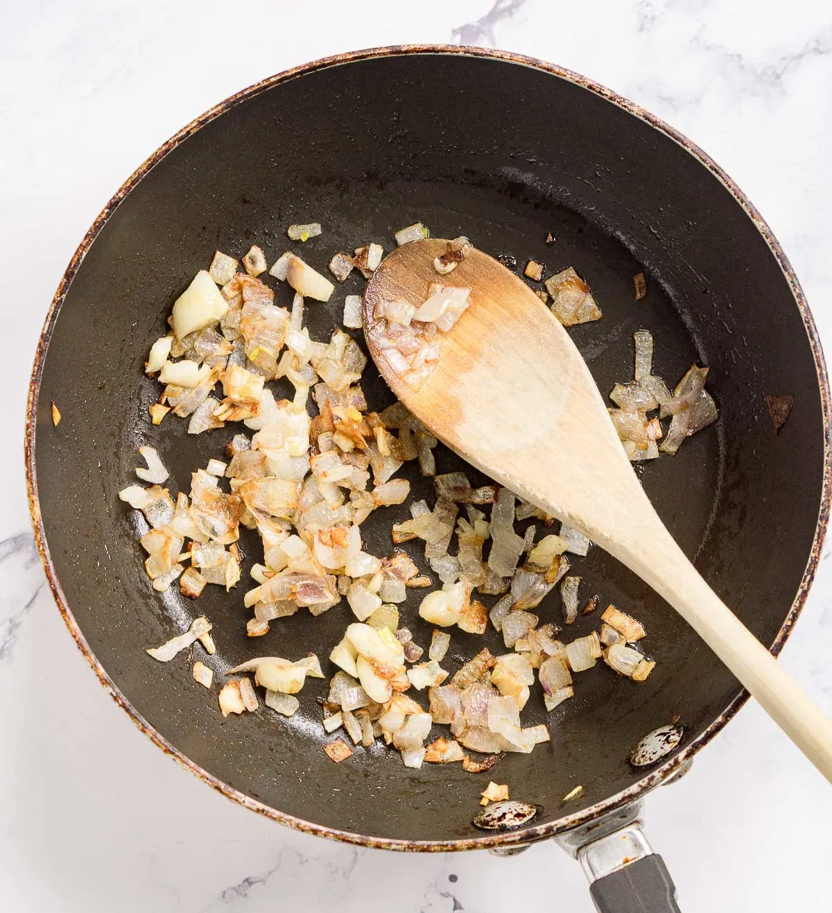 Sauteed diced shallot in a small skillet