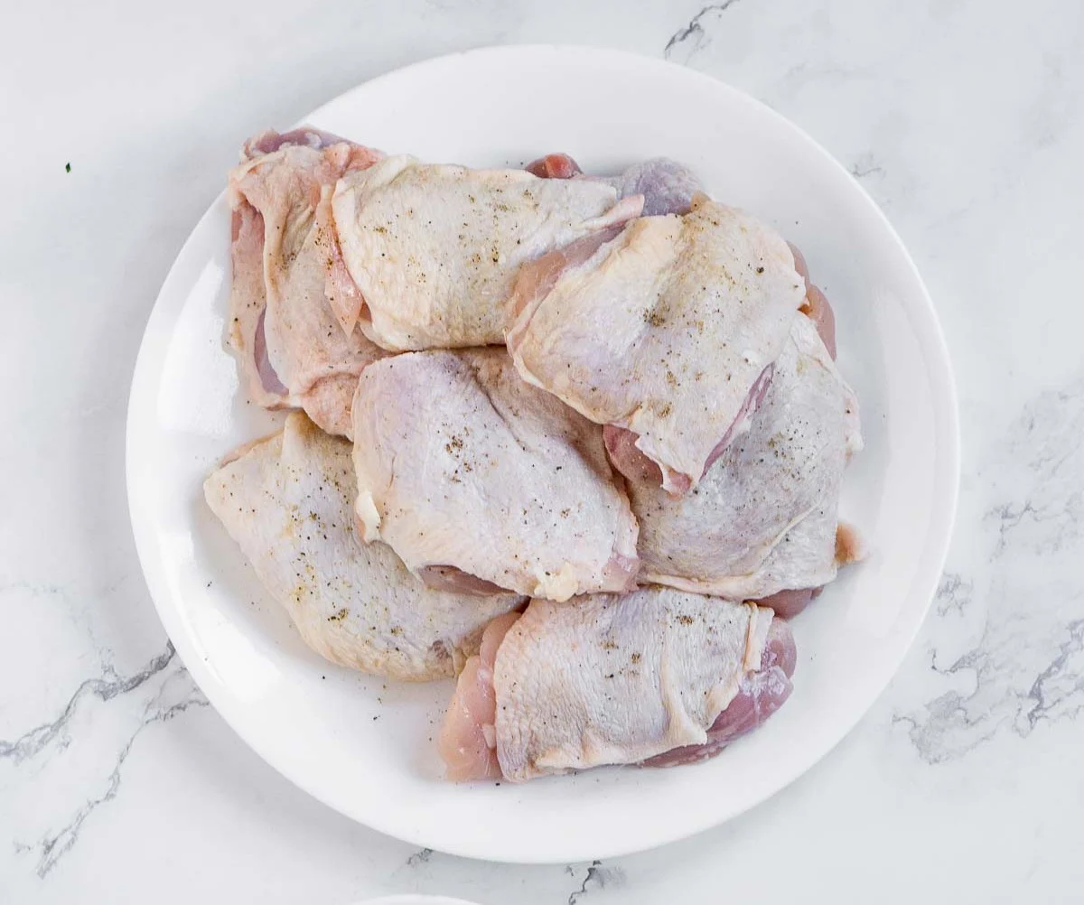 Chicken thighs seasoned with salt and pepper