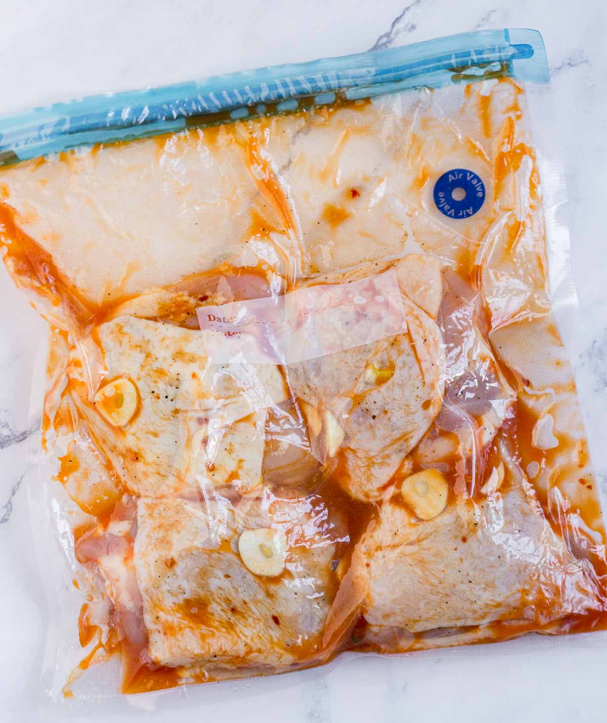 Chicken thighs with sauce in a sous vide bag