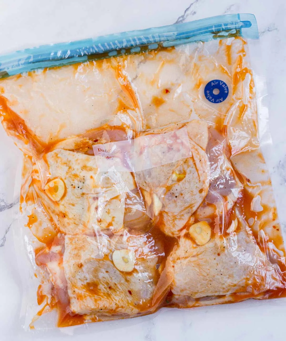 Chicken thighs with sauce in a sous vide bag