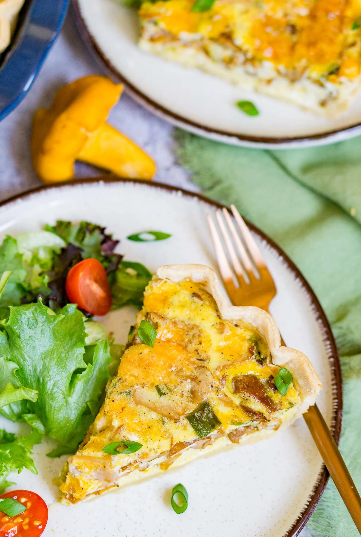 Slice of wild mushroom quiche on a plate