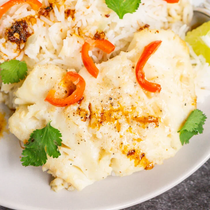 Close up of cod fillet poached in coconut broth
