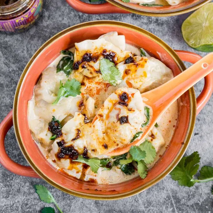 Bowl of coconut curry wonton soup with chili crisp oil