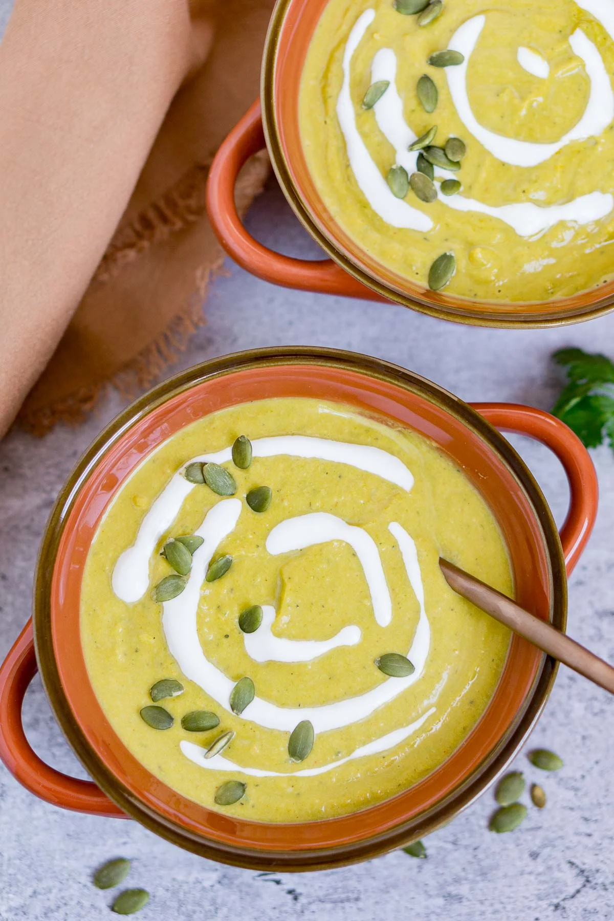 Bowls of pumpkin leek soup with sour cream garnish