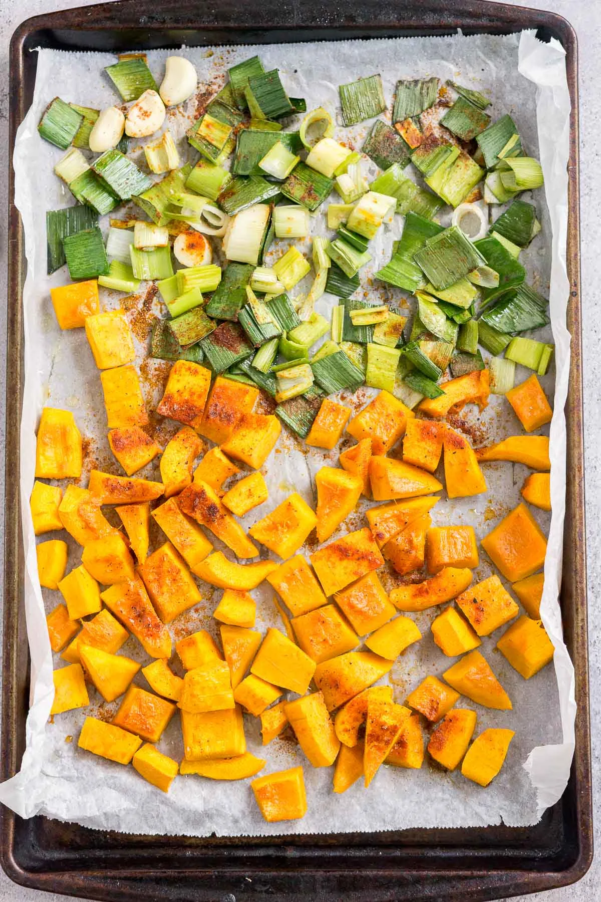 Roasted pumpkin and leek on a baking sheet